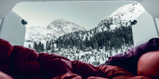 Blick aus dem Camper auf schneebedeckte Berge