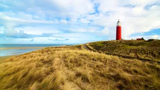 Leuchtturm auf Hügel am Meer in den Niederlanden