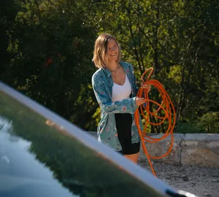 Woman camping with water hose